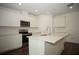 Modern white kitchen featuring an island, stainless steel appliances, and ample cabinetry at 9512 Summers Cay Cir, Thonotosassa, FL 33592