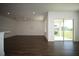 Bright open-concept living space with wood floors and sliding glass doors to the patio at 9512 Summers Cay Cir, Thonotosassa, FL 33592