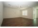 Spacious living room with dark wood floors, modern ceiling fan and sliding glass doors at 9512 Summers Cay Cir, Thonotosassa, FL 33592