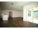 Open living space featuring dark wood floors, a kitchen island, and sliding glass doors at 9512 Summers Cay Cir, Thonotosassa, FL 33592