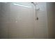 Shower with white tile, shower head, and a built in shower caddy at 9512 Summers Cay Cir, Thonotosassa, FL 33592