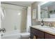 Bathroom with white tile walls, a vanity and a framed mirror at 9700 Starkey Rd # 325, Seminole, FL 33777