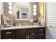 Bathroom featuring wood accents, granite countertop, and ample lighting at 9700 Starkey Rd # 325, Seminole, FL 33777