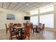 Bright dining room with tile floor, large windows, and multiple dining tables at 9700 Starkey Rd # 325, Seminole, FL 33777