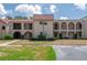Charming condo complex with red tile roof, arched balconies, and neat landscaping at 9700 Starkey Rd # 325, Seminole, FL 33777