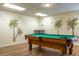 Amusement awaits in the game room, boasting a handsome pool table with tropical themed decor at 9700 Starkey Rd # 325, Seminole, FL 33777