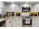 Well-equipped kitchen featuring modern appliances and stylish white cabinets at 9700 Starkey Rd # 325, Seminole, FL 33777