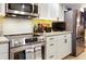 Stainless steel appliances complement the white cabinets and granite counters in this kitchen at 9700 Starkey Rd # 325, Seminole, FL 33777
