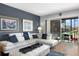 Comfortable living room with a large white sectional sofa and sliding glass door to the balcony at 9700 Starkey Rd # 325, Seminole, FL 33777