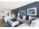 Bright living room featuring a white sofa set with navy pillows, wood floors, and elegant decor at 9700 Starkey Rd # 325, Seminole, FL 33777