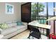 Enclosed lanai with a view of the surrounding community, with small table and loveseat at 9700 Starkey Rd # 325, Seminole, FL 33777