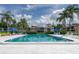 Community pool surrounded by lush landscaping and comfortable lounge chairs at 9700 Starkey Rd # 325, Seminole, FL 33777