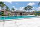 Community pool surrounded by lush landscaping and comfortable lounge chairs at 9700 Starkey Rd # 325, Seminole, FL 33777