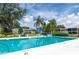 Community pool surrounded by lush landscaping and comfortable lounge chairs at 9700 Starkey Rd # 325, Seminole, FL 33777
