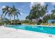 Community pool surrounded by lush landscaping and comfortable lounge chairs at 9700 Starkey Rd # 325, Seminole, FL 33777