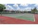 A well-maintained tennis court area with multiple courts and views of the surrounding community buildings at 9700 Starkey Rd # 325, Seminole, FL 33777