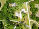 Overhead view of home with long driveway and nestled among the trees on a quiet street at 1025 Reading Rd, Lutz, FL 33558