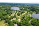 A beautiful aerial view shows the property's location near the lake and surrounded by lush greenery at 1025 Reading Rd, Lutz, FL 33558