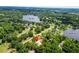 Stunning aerial view of the property, nestled near the lake with lush trees and foliage surrounding at 1025 Reading Rd, Lutz, FL 33558