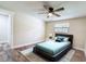 Comfortable bedroom features ceiling fan, wood-look floors, a window, and modern bed with plush pillows at 1025 Reading Rd, Lutz, FL 33558