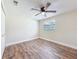 Bedroom with a modern ceiling fan and wood-look tile floors at 1025 Reading Rd, Lutz, FL 33558