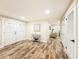 Bright entryway with wood floors, a decorative console table, and access to multiple rooms in the house at 1025 Reading Rd, Lutz, FL 33558