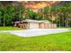 Charming single-story home featuring a stone exterior, mature landscaping, and a spacious front yard at 1025 Reading Rd, Lutz, FL 33558