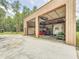 Exterior view of open two-car garage with stored vehicles and lawn equipment at 1025 Reading Rd, Lutz, FL 33558