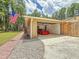 Charming open garage with a red sports car, brick walkway, and natural stone accents at 1025 Reading Rd, Lutz, FL 33558