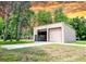 Large, detached garage with multiple bays, offering ample space for vehicles, storage, and workshop activities at 1025 Reading Rd, Lutz, FL 33558