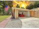Attached garage featuring a modern car, ample space, and convenient access from the driveway at 1025 Reading Rd, Lutz, FL 33558