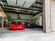 Spacious garage interior with multiple cars, motorcycle, and storage, offering ample space for vehicles and projects at 1025 Reading Rd, Lutz, FL 33558