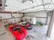 Spacious garage with metal walls housing multiple vehicles including a sports car and Airstream trailer at 1025 Reading Rd, Lutz, FL 33558