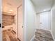 Hallway with wood-look floors leading to bathroom with tub at 1025 Reading Rd, Lutz, FL 33558