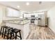Well-lit kitchen with white cabinets, stainless steel appliances, granite countertops, and a convenient breakfast bar at 1025 Reading Rd, Lutz, FL 33558