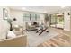 Bright living room with wood floors, comfortable seating, a modern rug, and a glass door to the patio at 1025 Reading Rd, Lutz, FL 33558