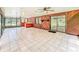Expansive living room features lots of natural light, wood paneled walls, and access to outdoor areas at 1025 Reading Rd, Lutz, FL 33558
