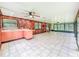 Expansive living room features lots of natural light, wood paneled walls, and access to the backyard at 1025 Reading Rd, Lutz, FL 33558