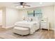 Bright bedroom with wood floors, white bedding, ceiling fan, and matching nightstands with lamps on each side at 1025 Reading Rd, Lutz, FL 33558