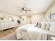 Serene bedroom with wood floors, neutral decor, a ceiling fan, and a dresser with decorative mirrors at 1025 Reading Rd, Lutz, FL 33558