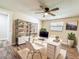 Home office with white desk, black shelving, and wood-look floors at 1025 Reading Rd, Lutz, FL 33558
