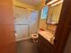 Small bathroom featuring a shower, and a wooden cabinet sink at 11394 Collingswood St, Spring Hill, FL 34608
