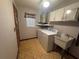 Functional laundry room equipped with a washer, dryer, and utility sink at 11394 Collingswood St, Spring Hill, FL 34608