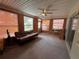 Cozy sun room featuring neutral carpeting, ample windows, and bright walls at 11394 Collingswood St, Spring Hill, FL 34608