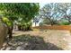 View of the backyard with a fire pit and tropical landscaping at 11988 117Th St, Seminole, FL 33778