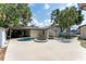 Backyard pool area with a jacuzzi, plenty of patio space, and a covered outdoor living area at 11988 117Th St, Seminole, FL 33778