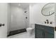 Updated bathroom features a marble-look tiled shower, vanity with black hardware, and modern fixtures at 11988 117Th St, Seminole, FL 33778