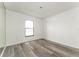 Bedroom showcasing wood-look floors and a large window that offers ample natural light at 11988 117Th St, Seminole, FL 33778