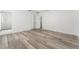 Bedroom featuring wood-look floors, a ceiling fan, and access to an en-suite bathroom at 11988 117Th St, Seminole, FL 33778