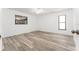 Spacious bedroom with neutral walls, a ceiling fan, and stylish wood-look flooring at 11988 117Th St, Seminole, FL 33778